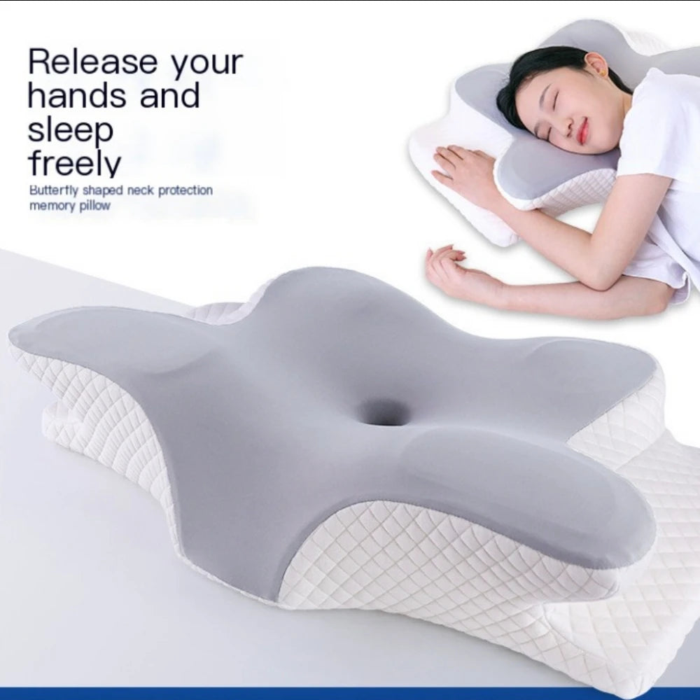 A gray and white butterfly-shaped memory foam neck pillow being used by a woman for sleep.