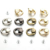 A collection of metal D-shaped ring bag handles in gold and silver finishes, shown with accompanying screws.