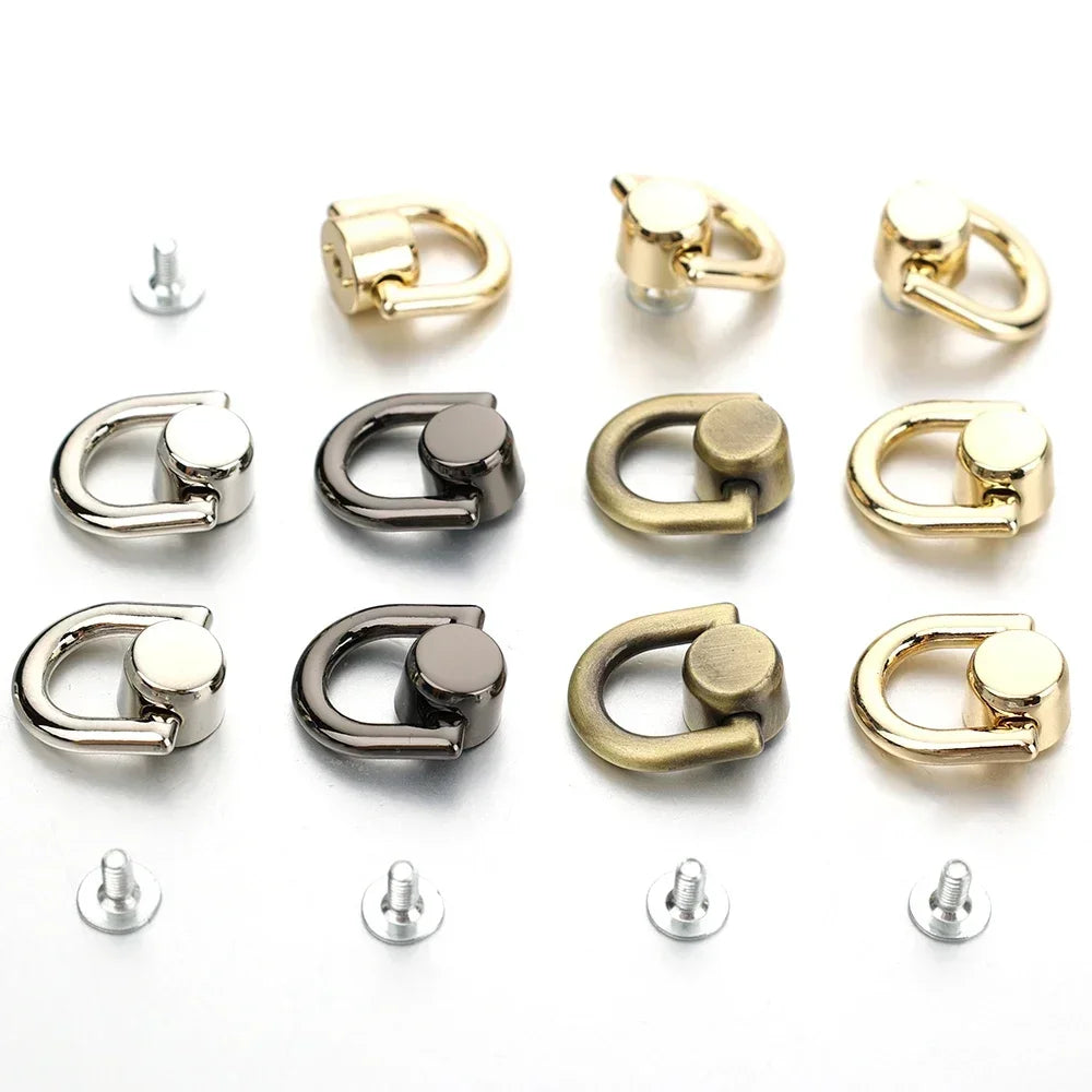 A collection of metal D-shaped ring bag handles in gold and silver finishes, shown with accompanying screws.