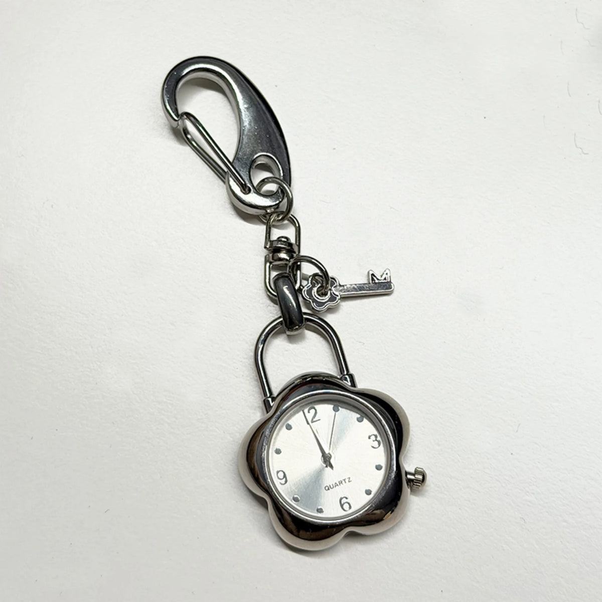 Silver keychain featuring a pocket watch with an adjustable clock face.