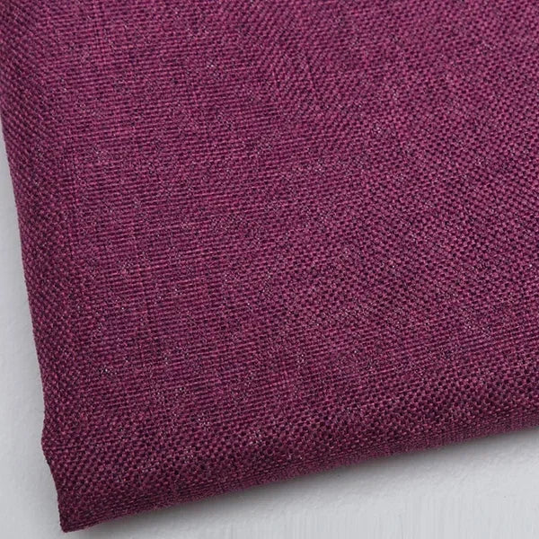 Close-up of a deep magenta coarse linen and cotton fabric textile.