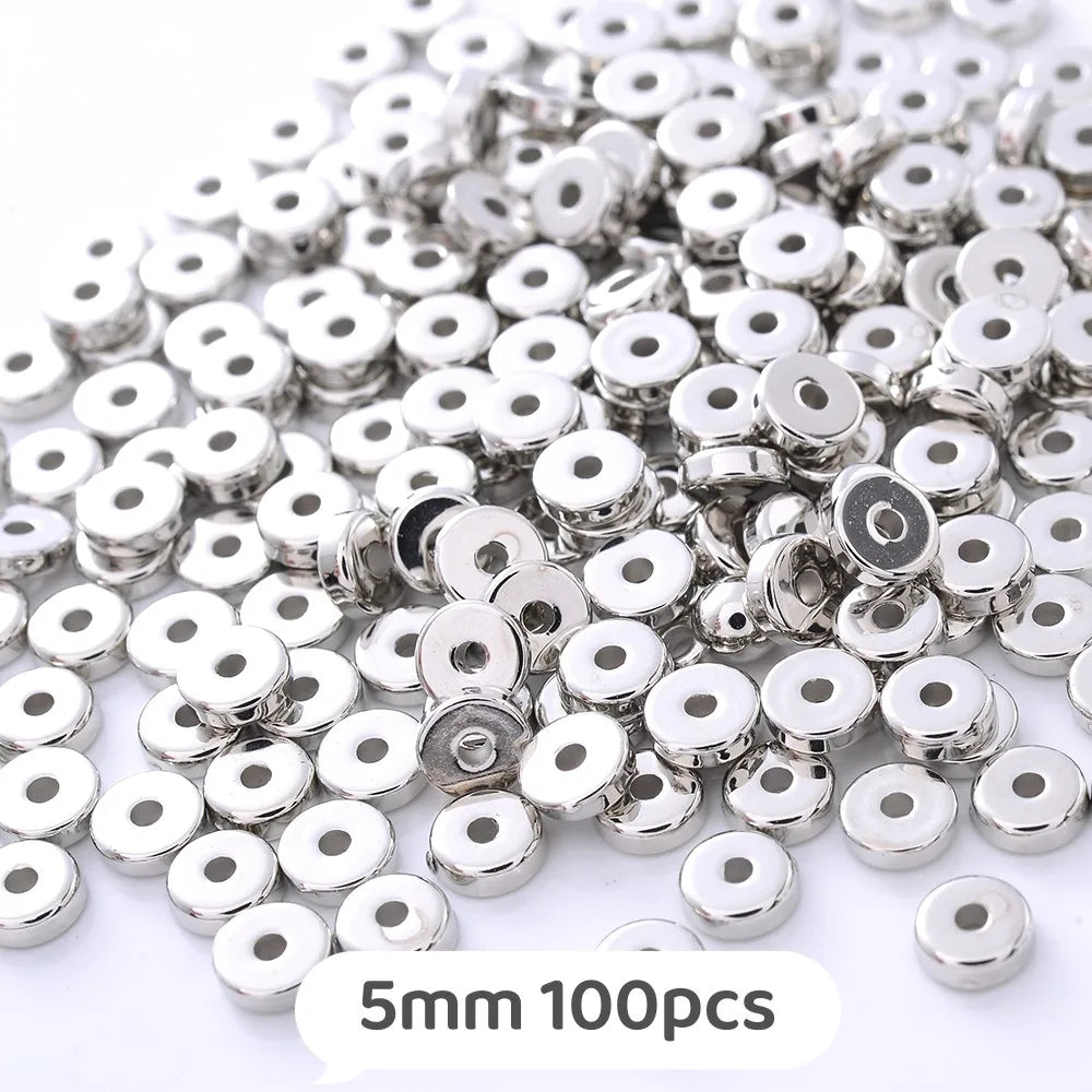 A pile of silver-colored geometric acrylic beads for jewelry making