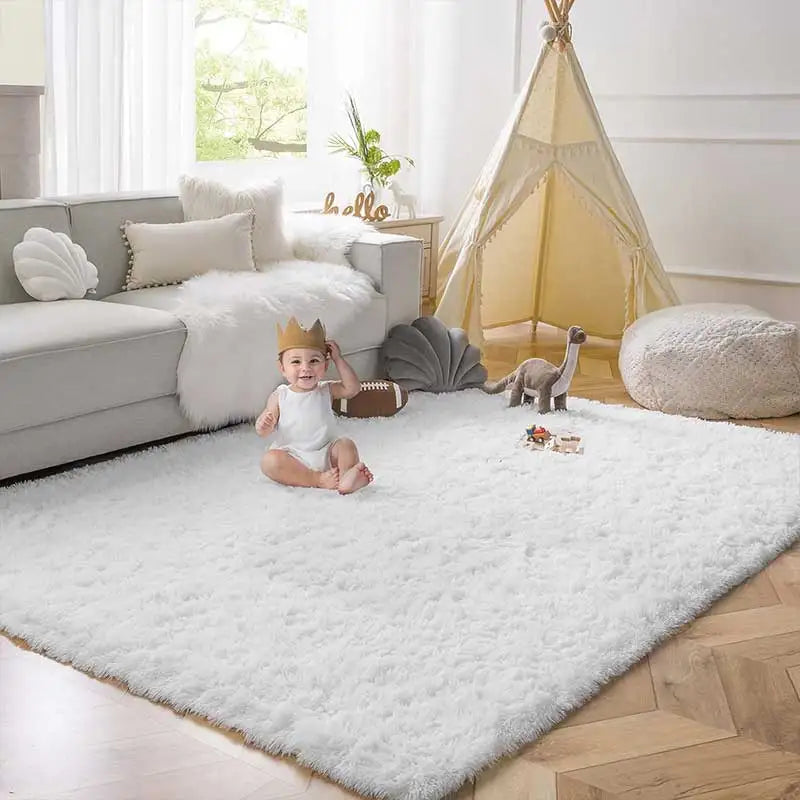 A baby sitting on a white shag rug in a bright living room with a yellow tent decoration.