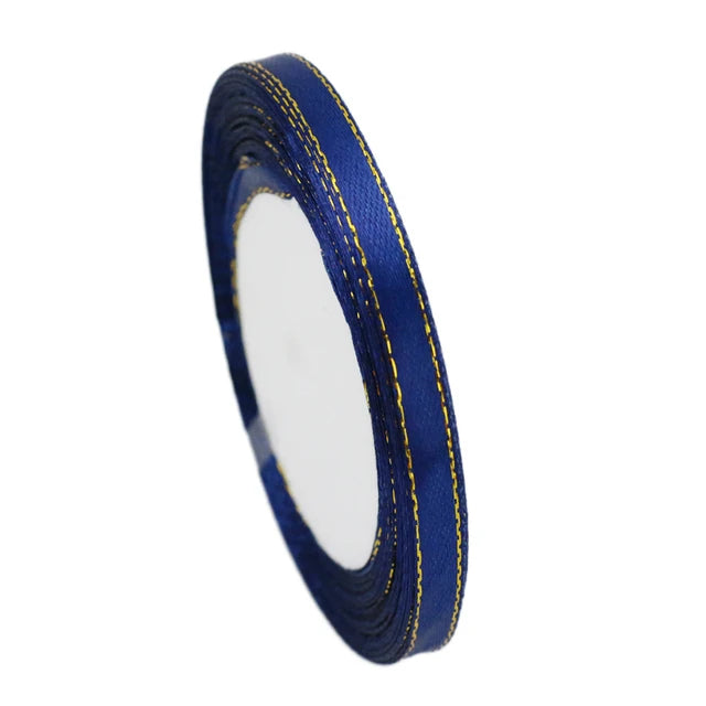 A roll of 6mm gold-edged satin ribbon in dark blue for gift wrapping and crafts.