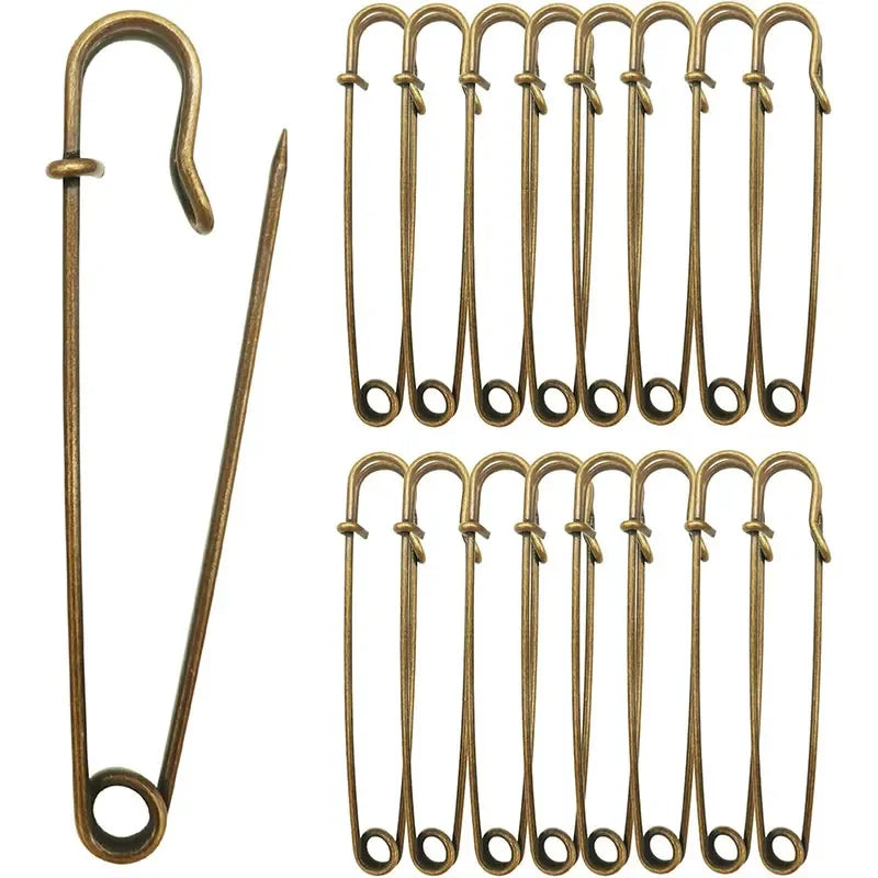 A set of heavy duty stainless steel safety pins in a vertical arrangement.