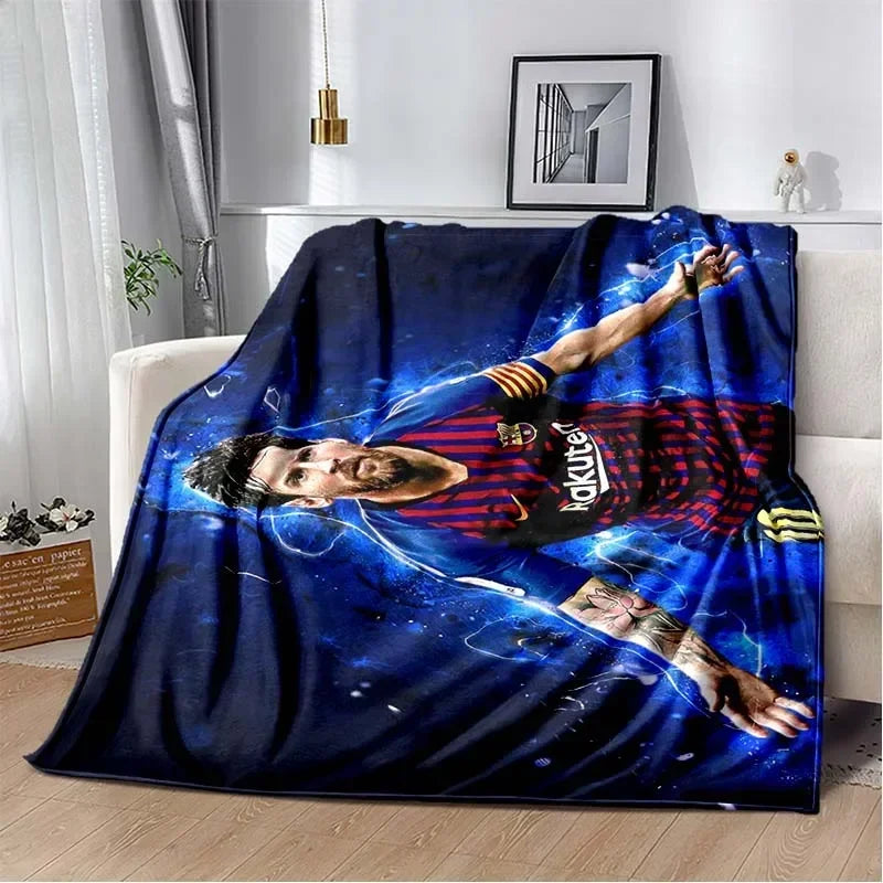 A dark blue blanket featuring a graphic of a man with dark hair and beard in a dynamic pose against a starry background.