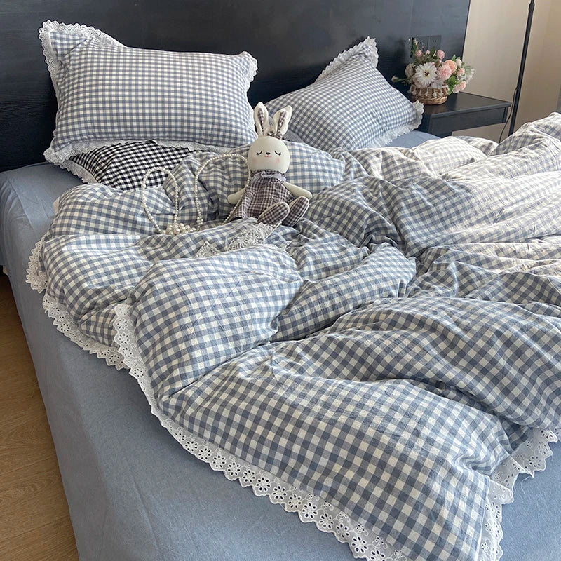 A plaid duvet cover and pillowcase set in blue and white checkered fabric with a decorative bunny pillow.