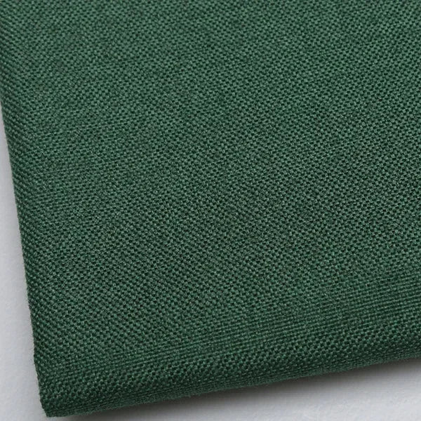 A close-up view of coarse green linen and cotton fabric for DIY projects.