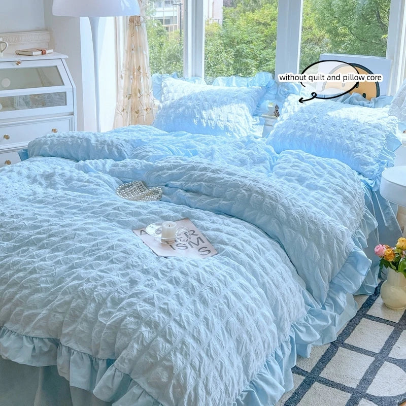 Light blue lace seersucker duvet cover set displayed on a bed with white and gray accents.