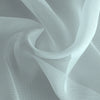 Flowing sheer voile curtain panel in light gray fabric draped softly.