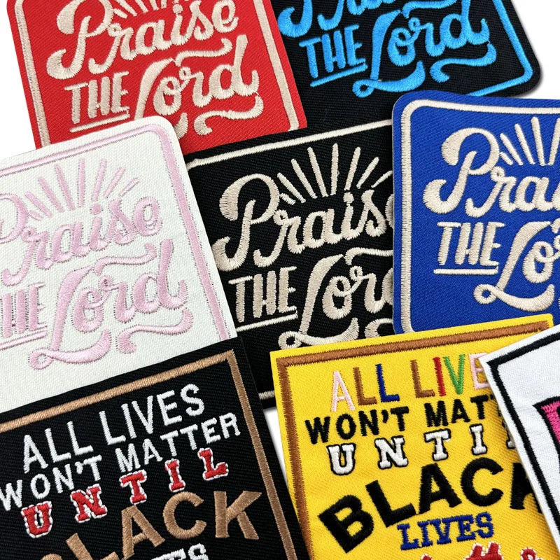 A collection of embroidered iron-on clothing patches featuring phrases like Praise The Lord and All Lives Won't Matter Until 