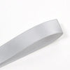 A roll of white double-sided satin craft ribbon shown diagonally.