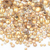 A pile of clear and gold glass rhinestones for DIY crafts