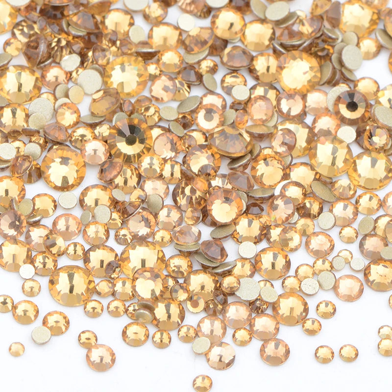 A pile of clear and gold glass rhinestones for DIY crafts