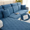 A deep blue jacquard plush sofa cushion cover featuring an intricate diamond pattern on a modern sofa.
