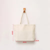 A beige canvas tote bag with wooden handles is shown against a white background.