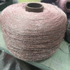 A large spool of glitter metallic yarn used for crochet and knitting.