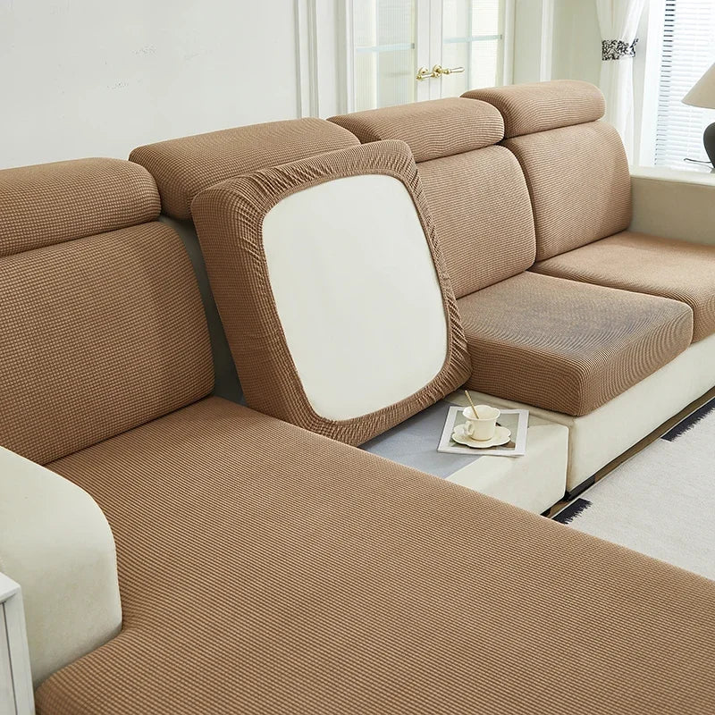 A beige jacquard elastic sofa cushion slipcover shown in a living room setting.