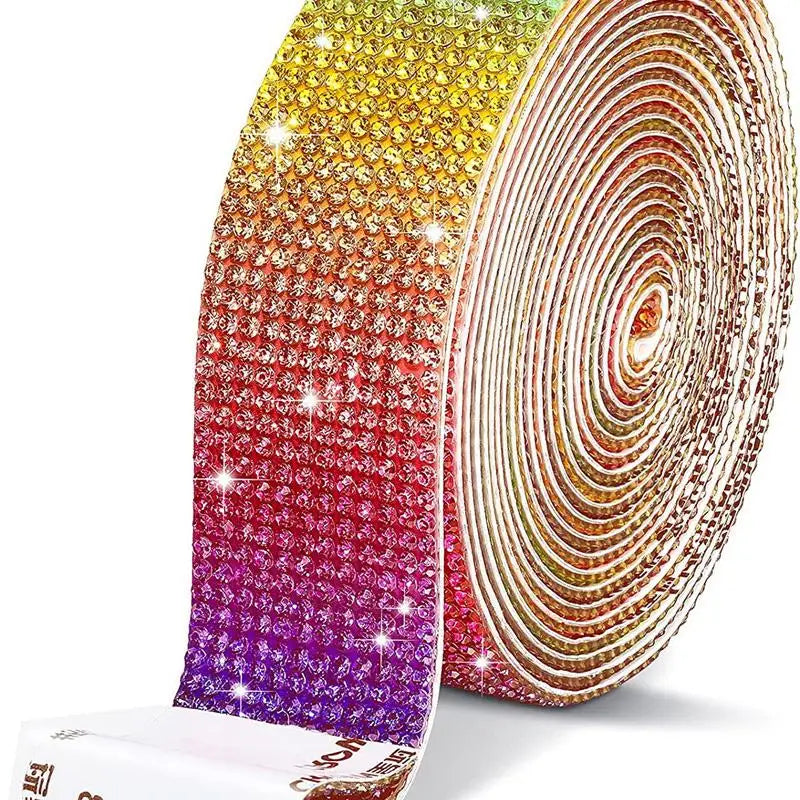 A roll of crystal rhinestone sticker ribbon featuring a rainbow gradient of colors for crafts and decor.