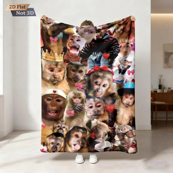 A 2D flat print of multiple monkey faces in various expressions on a blanket.