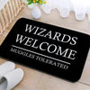 Black entrance mat with white text reading Wizards Welcome Muggle Tolerated