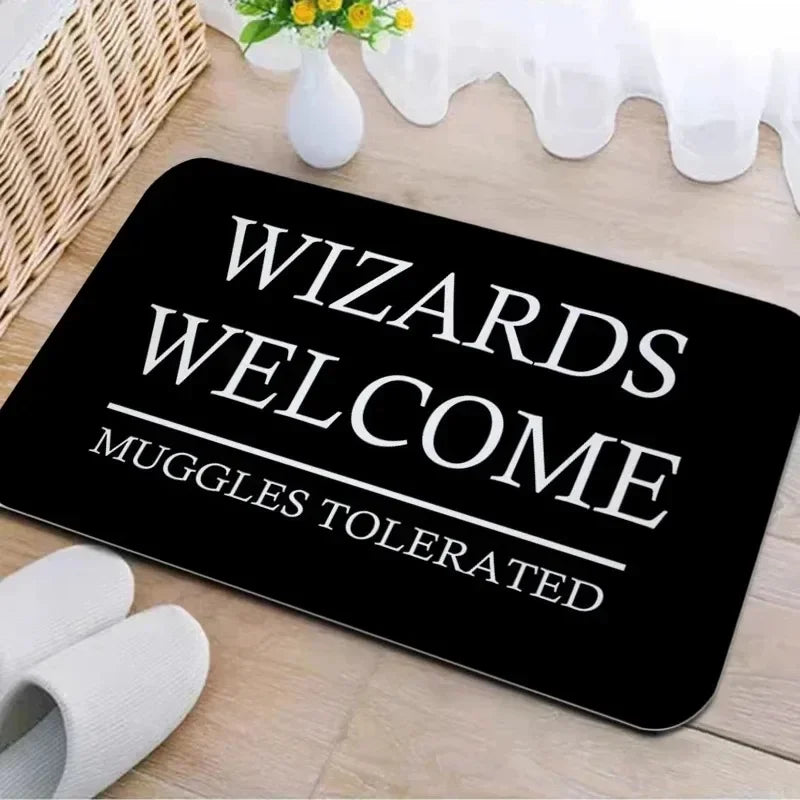 Black entrance mat with white text reading Wizards Welcome Muggle Tolerated