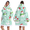 A woman models a light green patchwork fleece hoodie with white and red snowflake designs.