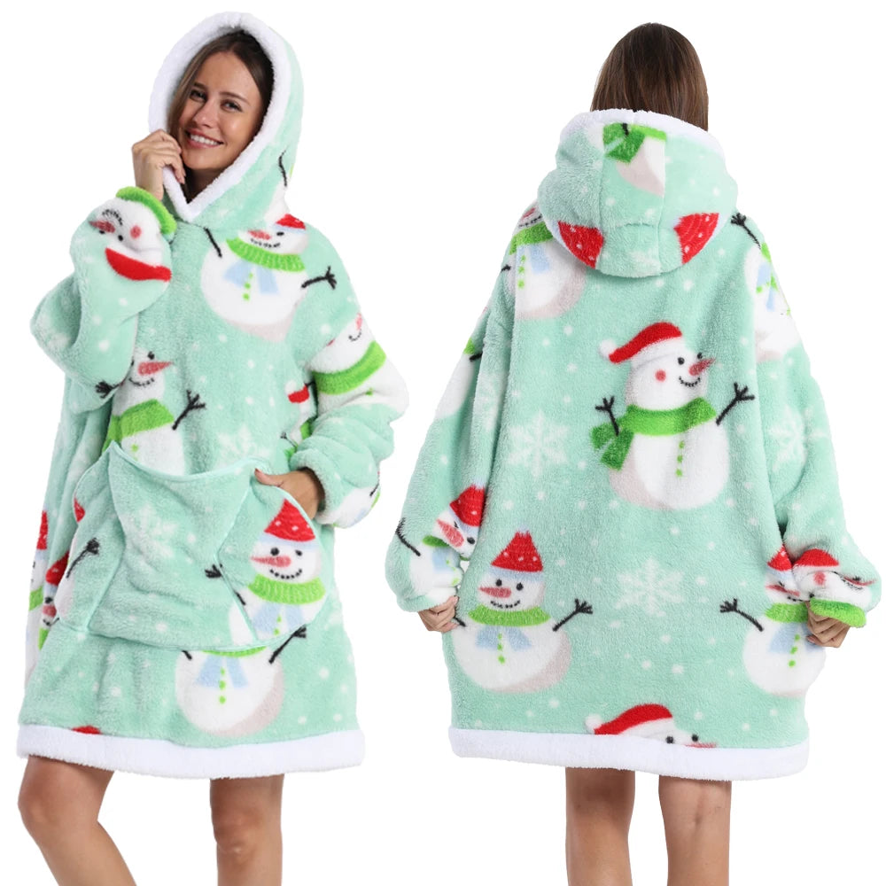 A woman models a light green patchwork fleece hoodie with white and red snowflake designs.