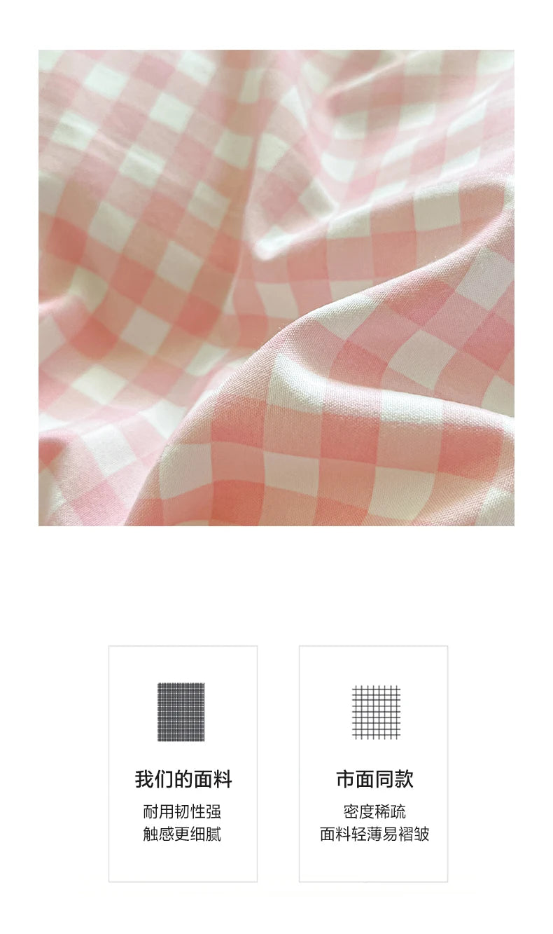 Close-up of a pink and white checkered fabric texture showing soft folds and drape.