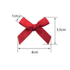 A red satin ribbon bow shown with dimensions of 1cm thickness, 4cm width, and 3.5cm height.