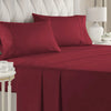 A set of deep red microfiber bed sheets with piping and deep pockets on a bed.