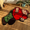 A red cartoon rug shaped like a person lying down on a wooden floor.