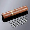 A wooden case containing a set of 25 large eye hand sewing needles.