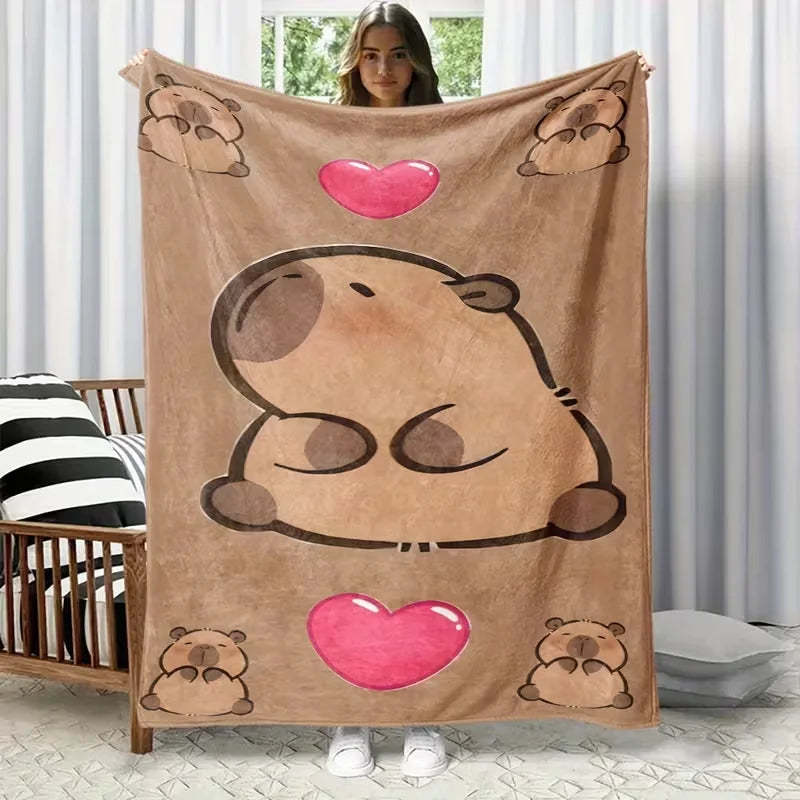 A plush flannel blanket featuring a cartoon bear print hanging on a wall.