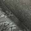 Close-up view of a dark gray plush cartoon area rug with white polka dots.