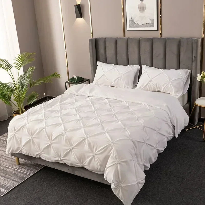 White quilted bedding set featuring a tufted headboard and pillows in a bedroom setting.