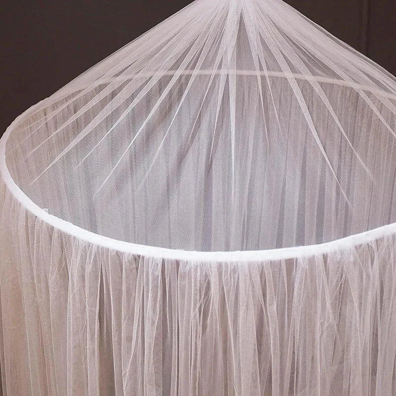 A sheer, light beige dome mosquito net draped over a frame.