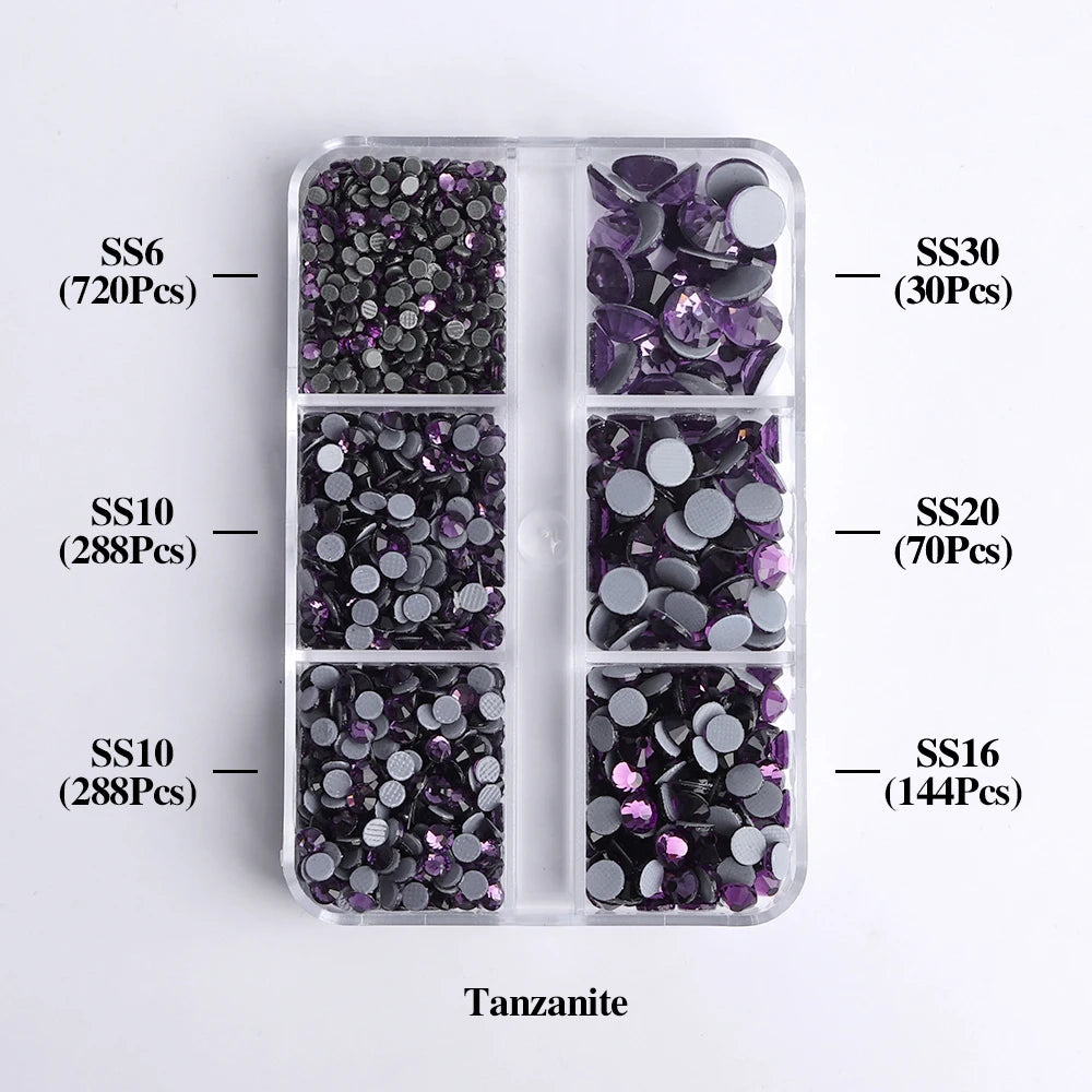 A clear plastic tray holds various sizes of purple and silver Tanzanite glass rhinestones categorized by SS6, SS10, SS10, SS2