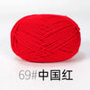 A ball of bright red organic cotton 4ply knitting yarn for crafts.