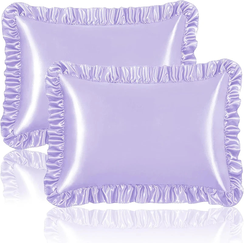 A set of two ruffled satin pillowcases in light purple with silky envelope closures.