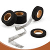 Rolls of black heavy duty iron-on hemming tape with a loose strip unwinding