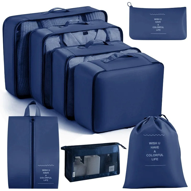 A set of blue travel storage organizers including zippered bags and a clear storage box