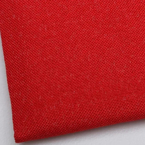 A close-up of a vibrant red coarse linen and cotton fabric textile.