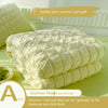 A stack of yellow bubble yarn summer cool quilt with a label describing it as soybean fiber and delicate for maternal and chi