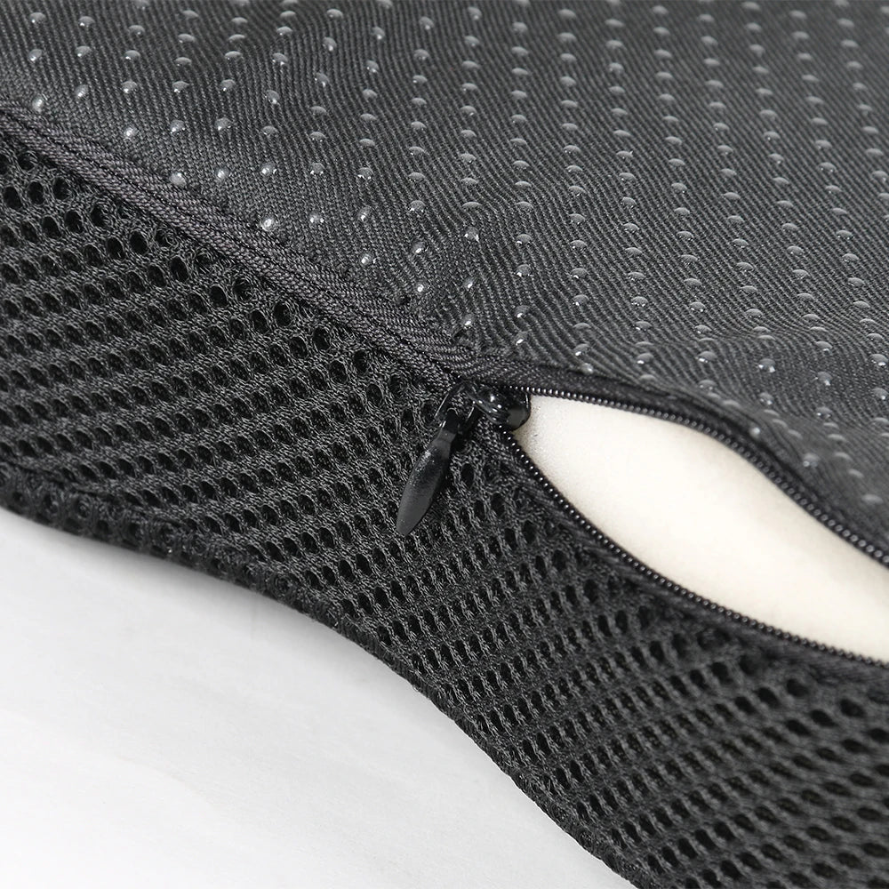 Black ergonomic U-shaped massage seat cushion with a mesh texture and a zippered opening.