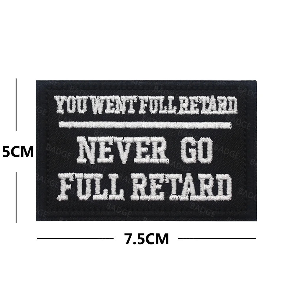 Black embroidered patch with white text saying You Went Full Retard Never Go Full Retard