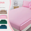 A pink satin pillowcase set displayed on a bed with various color options shown nearby.