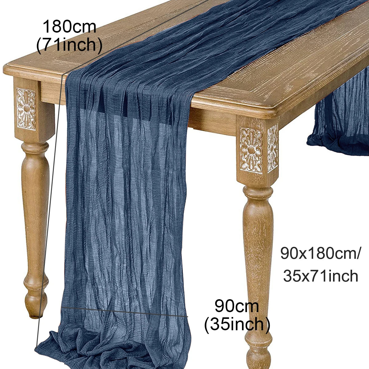A dark blue semi-sheer gauze table runner draped over a wooden table.