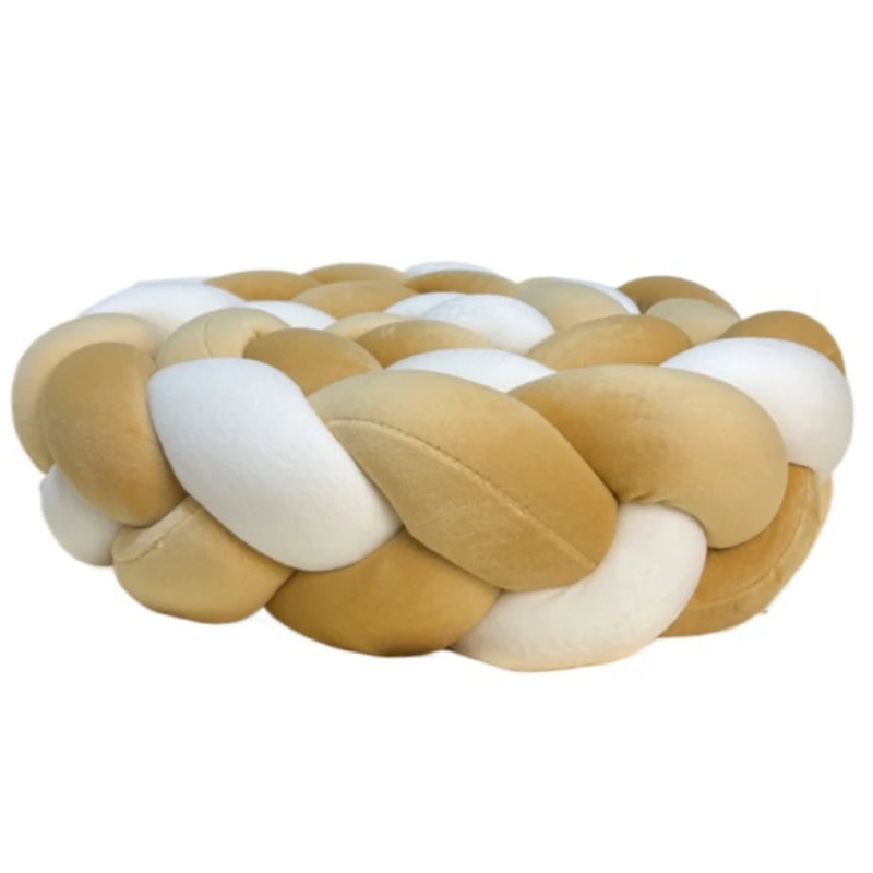 Handmade knotted floor mat for bed decor featuring woven beige and white fibers.