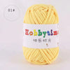 A ball of bright yellow thick polyester craft yarn for knitting and crochet